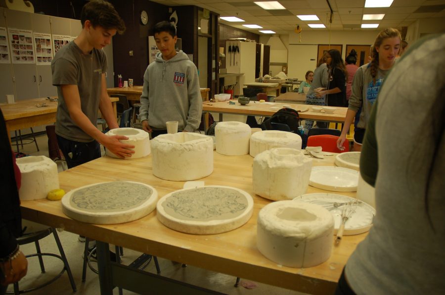 Students work on sculptures. 