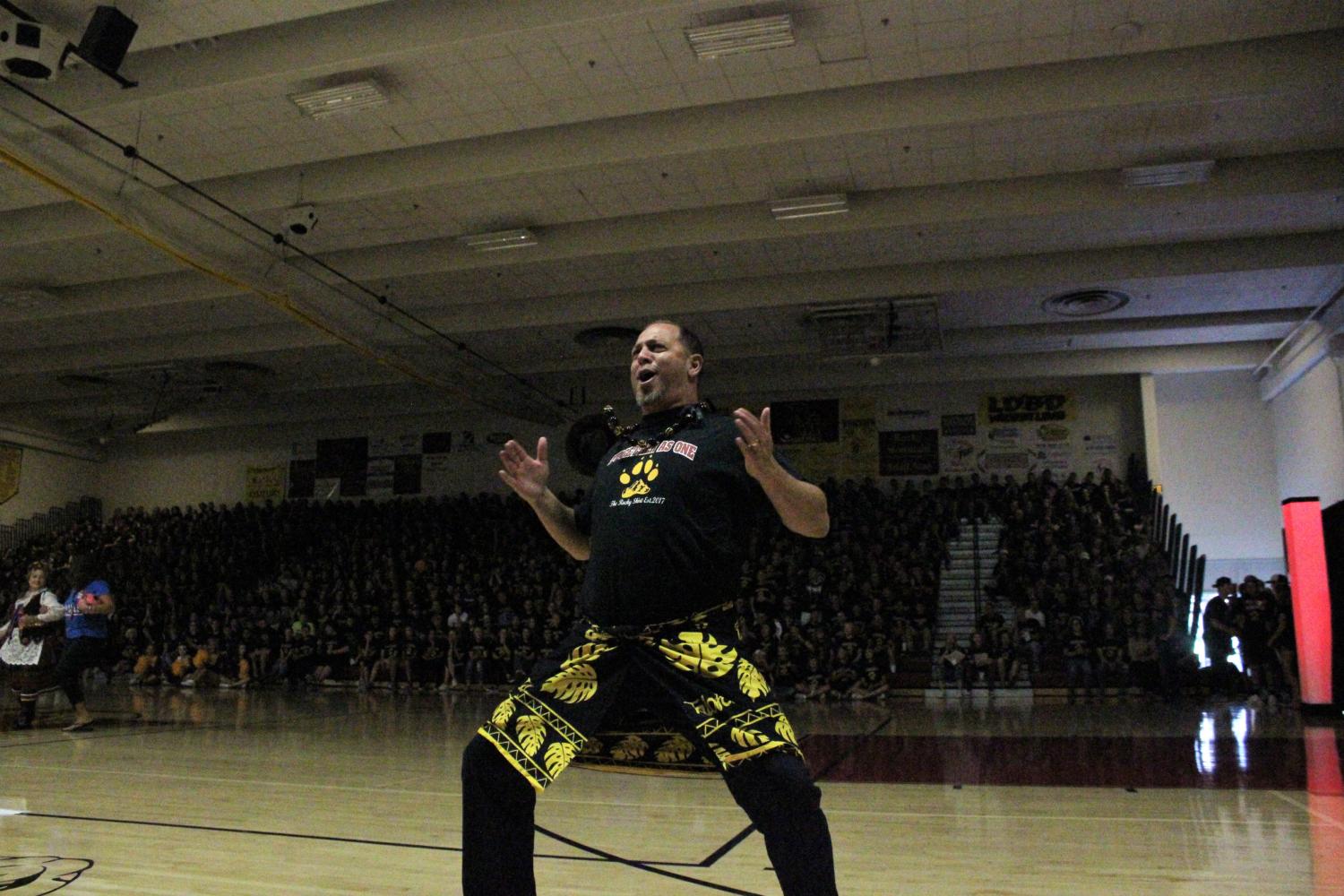 Mr. Liufau helping out with the homecoming reveal at the back to school assembly.