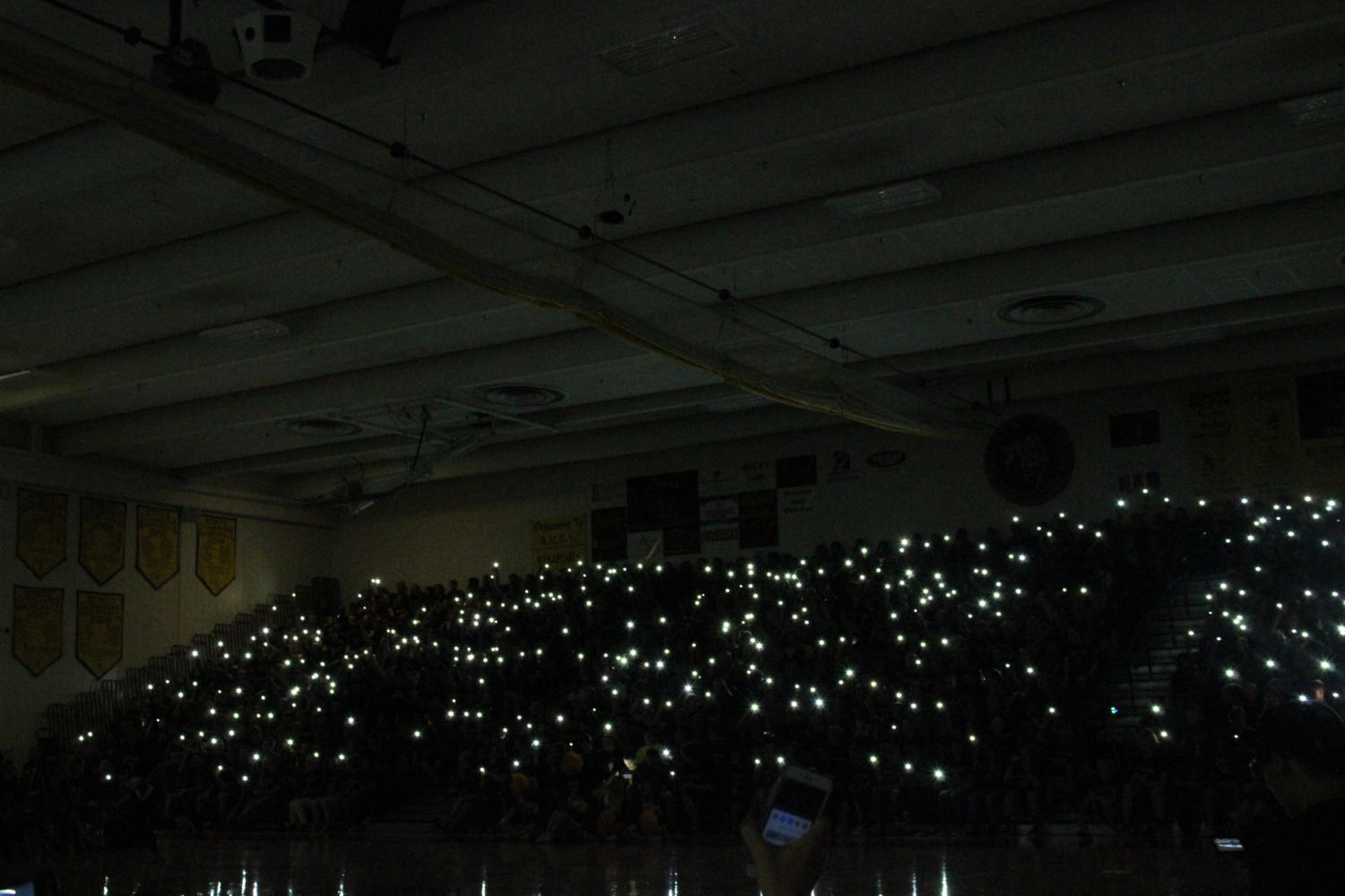 Rocky students shining their flashlights at the back to school assembly in 2017.