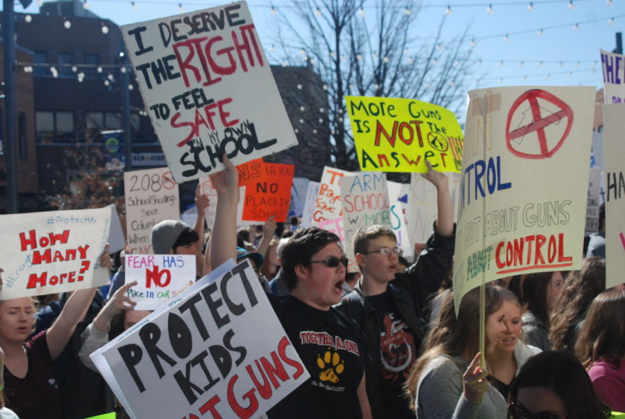 Student from all over the Poudre School District hold up signs and protest gun violence.