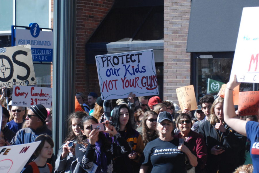 Protect our kids not your guns, says a sign in Old Town Square as people of all ages gather to protest gun violence in schools 