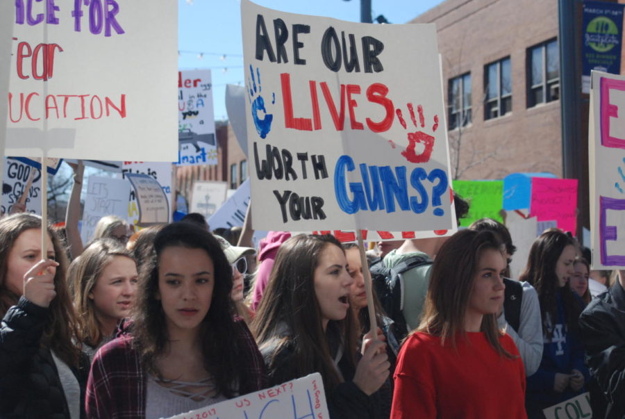 Are our lives worth your guns? Students in Old Town square hold up signs as they chant and speak out about gun control.