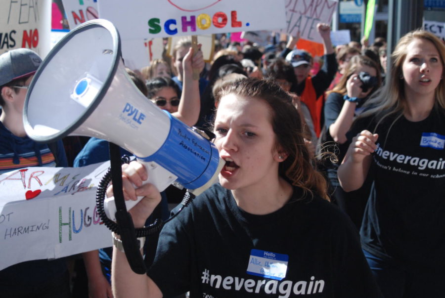 Volunteers with #neveragain speak out about gun violence in schools and demand change. 
