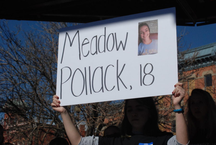 Students hold up signs of other students who have died in school shootings, at the walk out on Tuesday afternoon