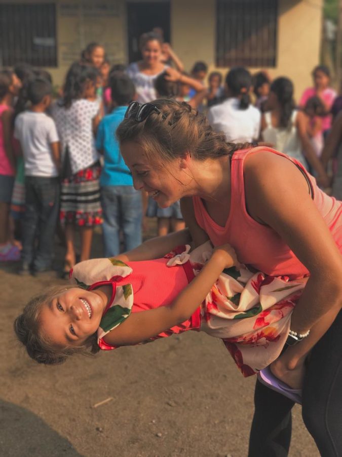 2017+Rocky+grad+Natalie+Bradshaw+plays+with+a+child+while+volunteering+during+her+gap+year+in+Nicaragua.+More+students+are+pursuing+a+nontraditional+path+post-graduation.+Contributed+photo.