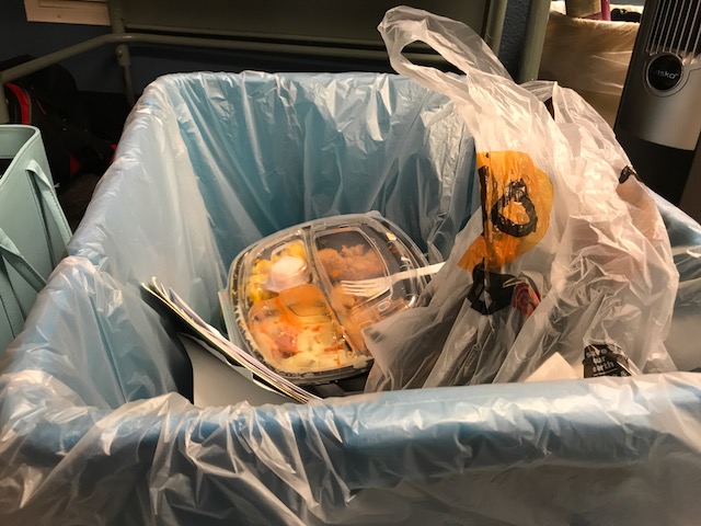 Students' left over lunches sit in the recycle bin, deeming all other recyclable items contaminated.