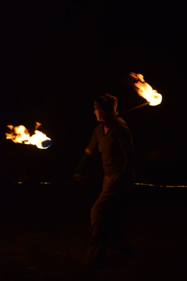 Different people that fire dance often have different preferences on their tools. Pictured is a double wick fire staff which is often balanced on the shoulders and swung around.