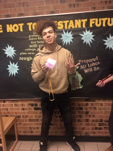 Junior Jaidon Lovato poses with his purple hall pass from Sawatch; hall passes are color coordinated to correspond to each section of the building. 