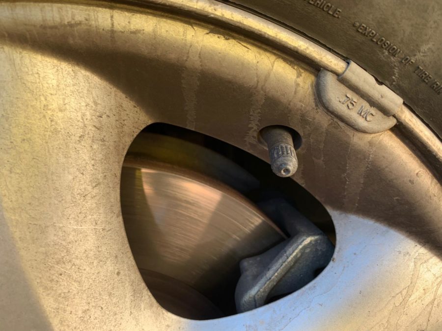 Many gas stations will have a free or very cheap tire filling station. The filler will be placed on this small tube on the tire (after the cap is removed, of course). 