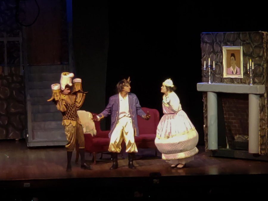 Mrs. Potts (Emma Stone) and Lumiere (Brock Lewis) give the Beast (Michael Naffier) advice.