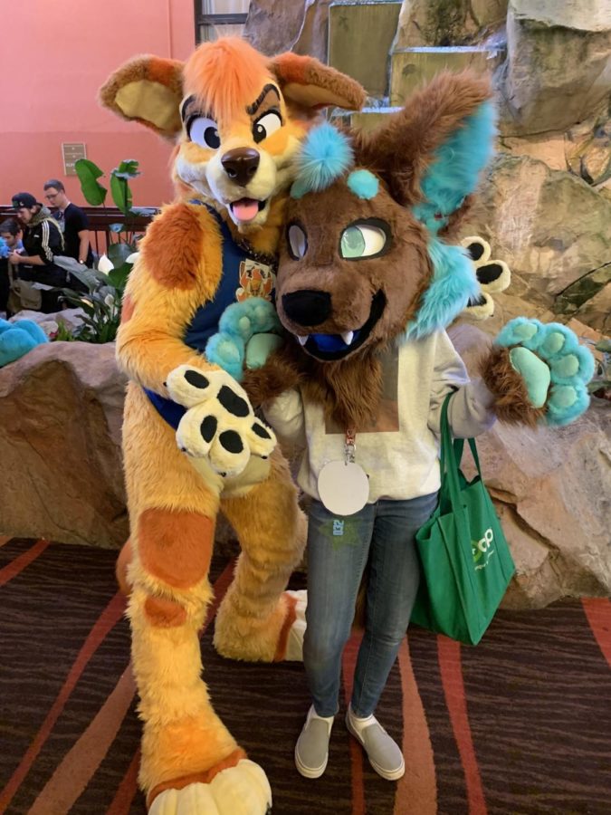 Liddle (right) and a friend (left) wear their fursuits.