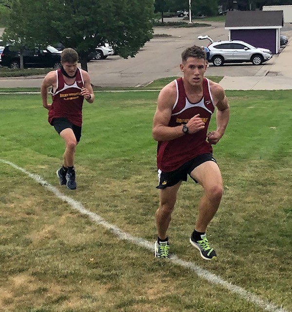 Matt Kinerson and Kolton Strait battle up a hill during a race at Fort Collins High school.