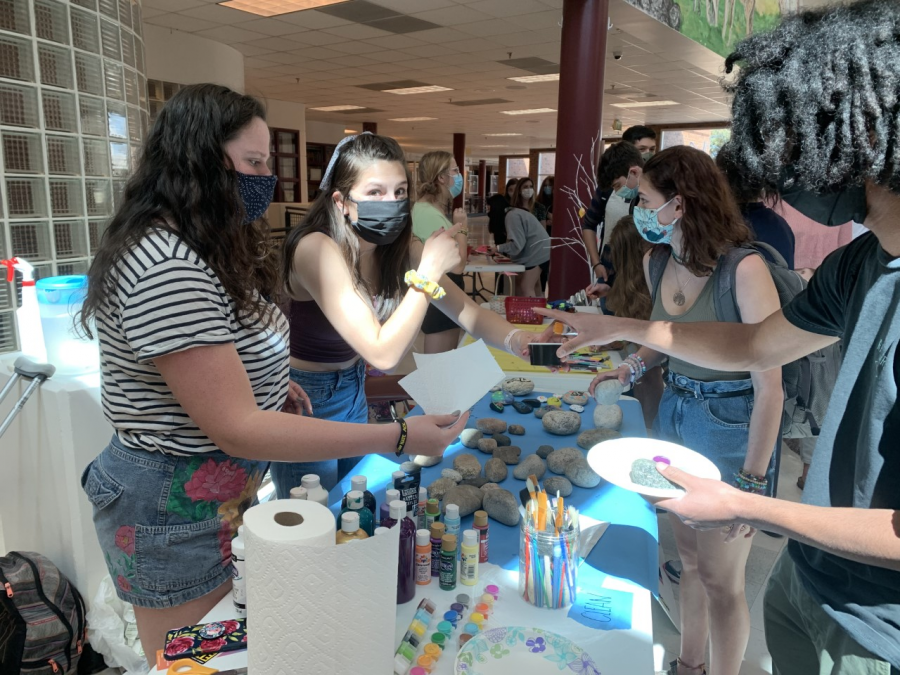 RMHS Peers Adilyn Prutch and Camille Long-Shore help students decorate rocks for the Peers Kindness Rock Garden at the No Place For Hate event. 