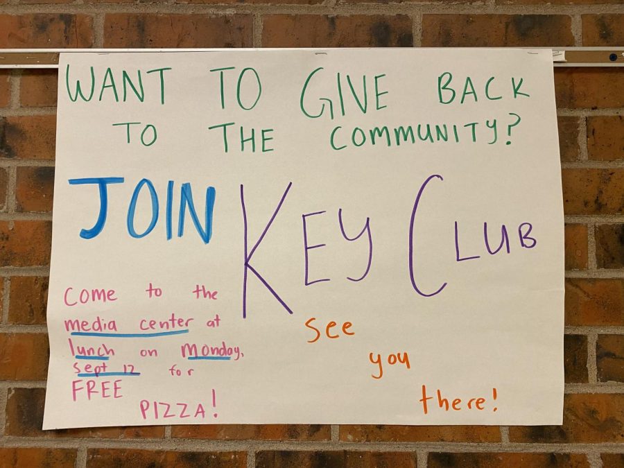 A sign in the Rocky hallway explaining when the key club meeting is. 