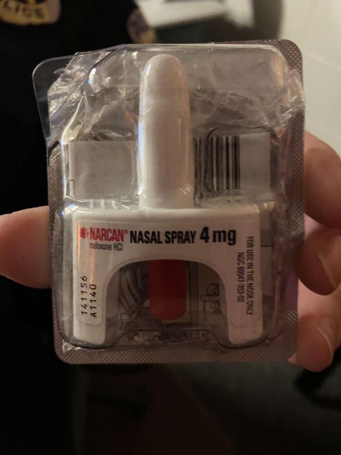 A Narcan dose, held by officer Sarah Klich, who is authorized to administer it.