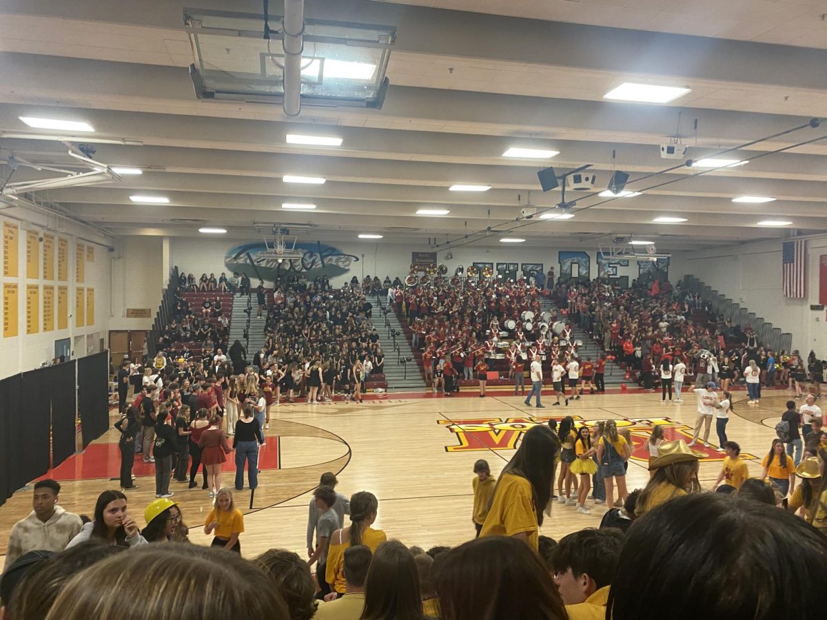 Students+fill+the+bleachers+and+the+Rocky+Mountain+Singers+get+ready+to+start+the+assembly+with+the+national+anthem.