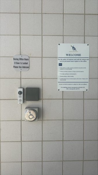 Front door at Rocky with handicap button and welcome sign, where people can get their first glimpse of accessibility at the school. 