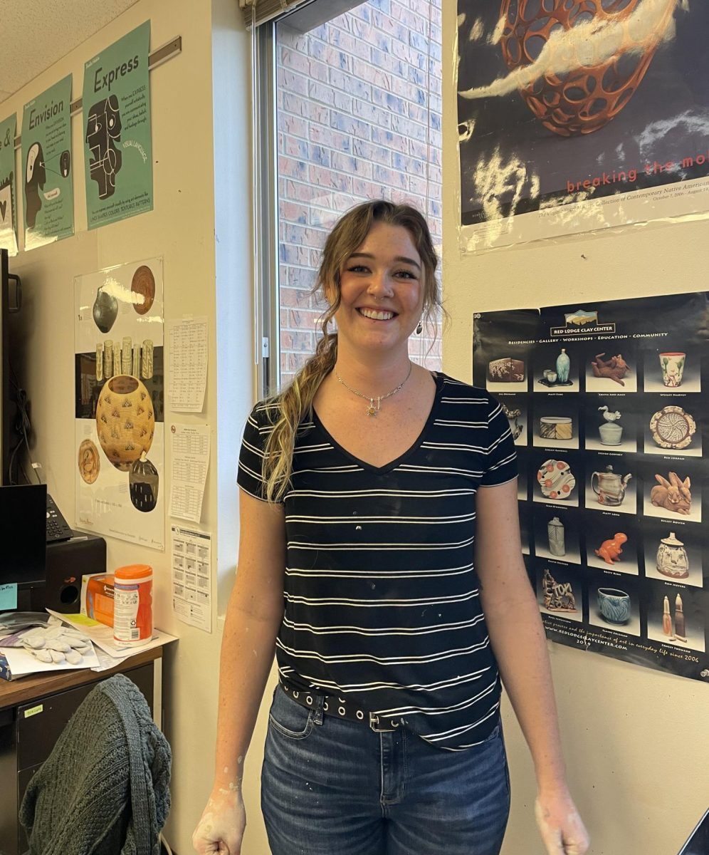 Madison Johnson (MJ) poses in the pottery room as she prepares for her class. 