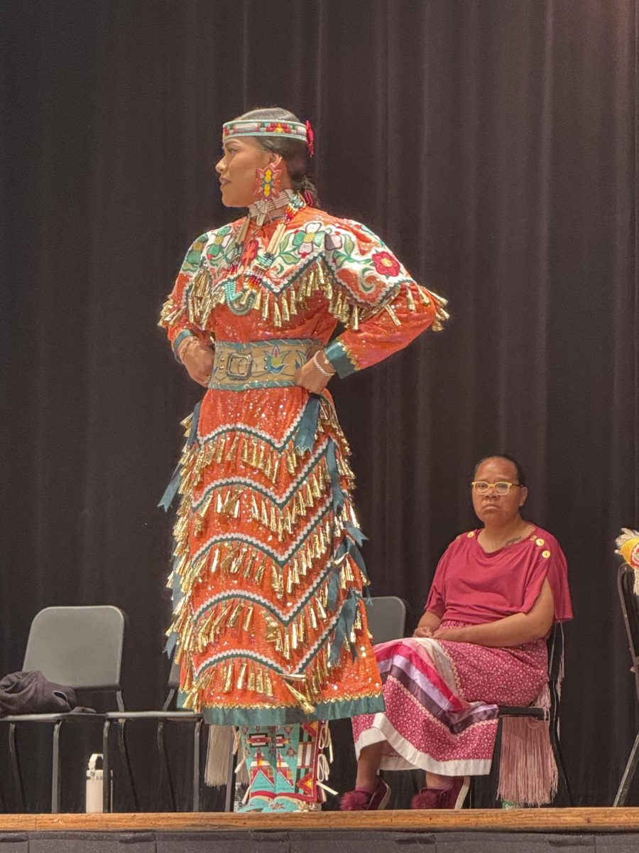 Amaya shows students native dances wearing a jingle dress. 