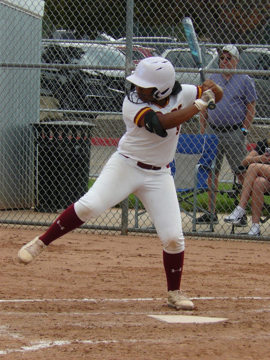 Varsity player Ari Jackson (senior) swings and misses the ball for a strike against ThunderRidge High School. 