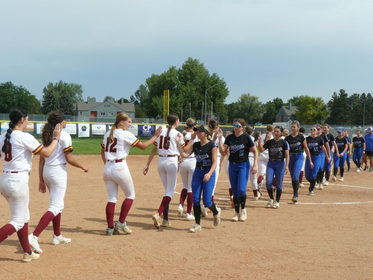 The teams take a minute for some post-game sportsmanship after their first tournament game.
