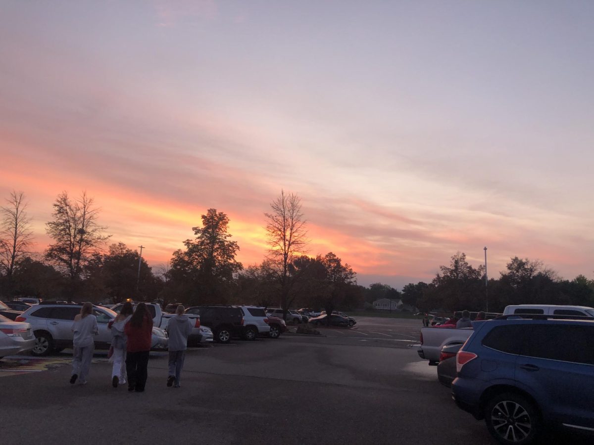 The sun rises at 6:22 am as students watch from the parking lot on August 26. 