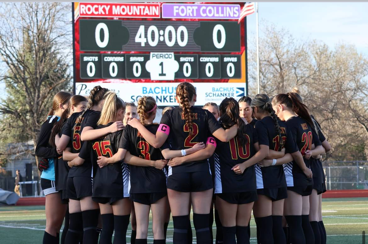 The Rocky girls soccer team huddles before kickoff in a rivalry match against Fort Collins High School. Many student athletes face challenges balancing performance, academics, and mentally health through out the season and rely on each other to handle the pressure of competition. 
