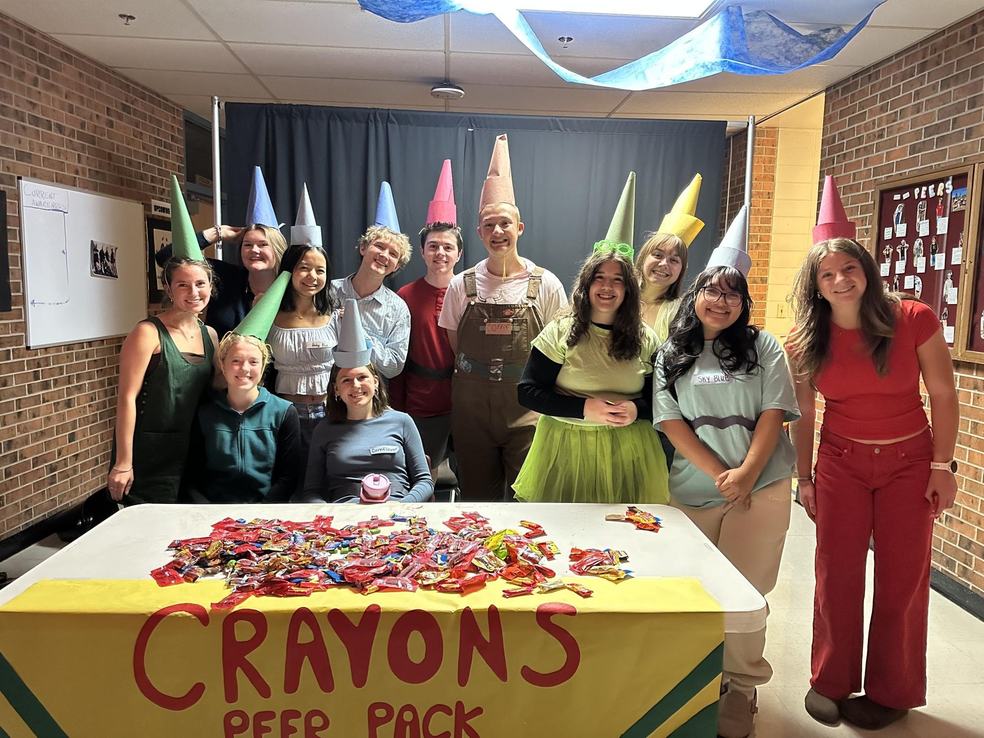 The Peers dress as a pack of crayons for Trick or Treat Street. 