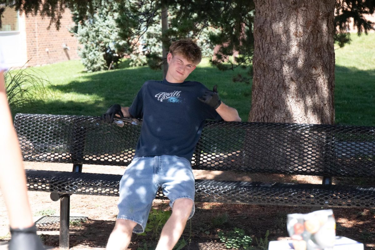 Dylan Farnsworth takes a break between cooking hot dogs at the Weenie Roast during Homecoming week. 