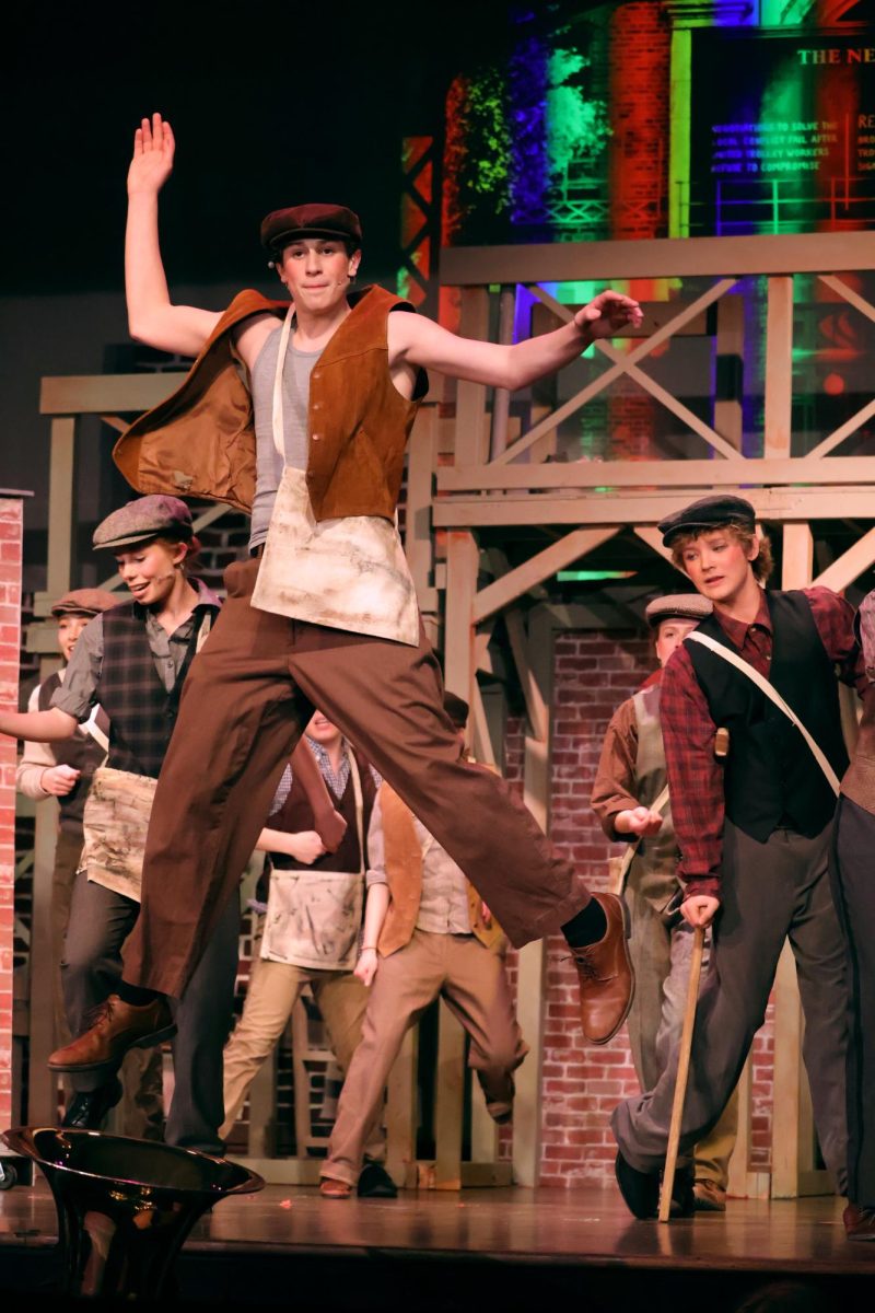 The "newsies" break into song before deciding to go on strike.