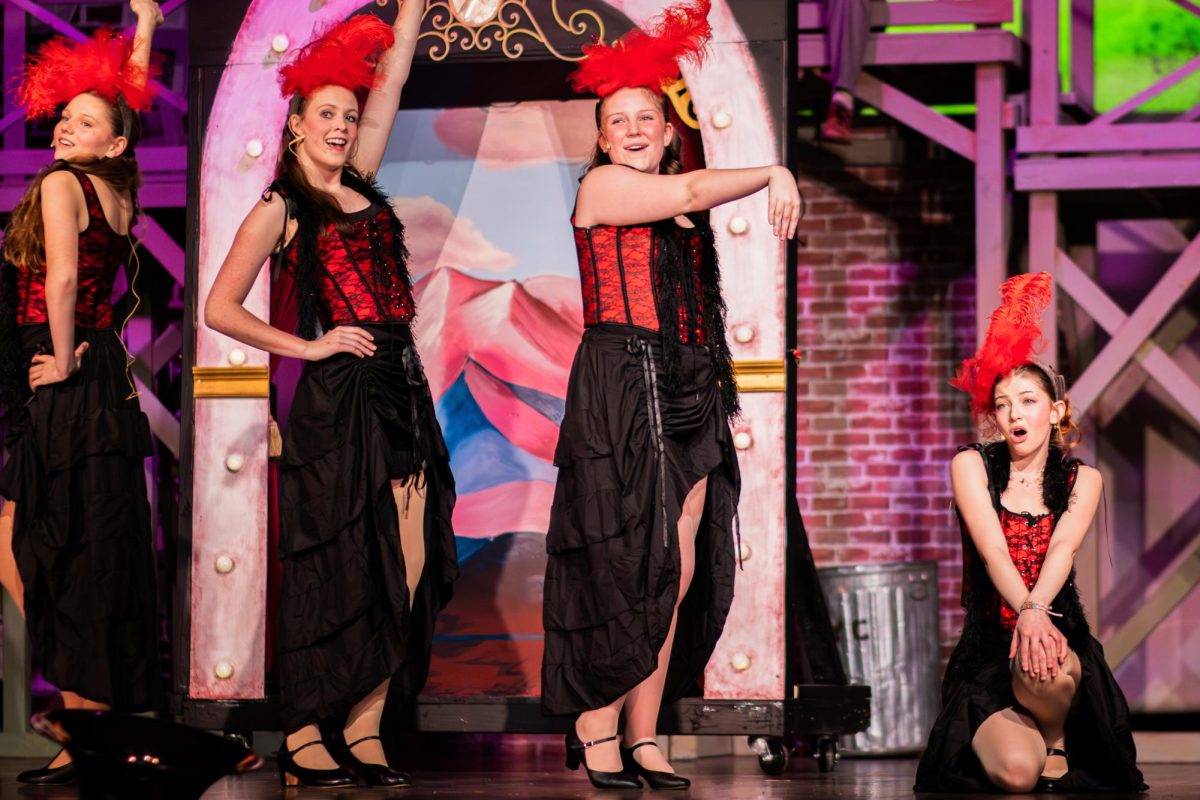 Senior Claire McCance sings with the other showgirls during a number in the spring musical "Newsies."