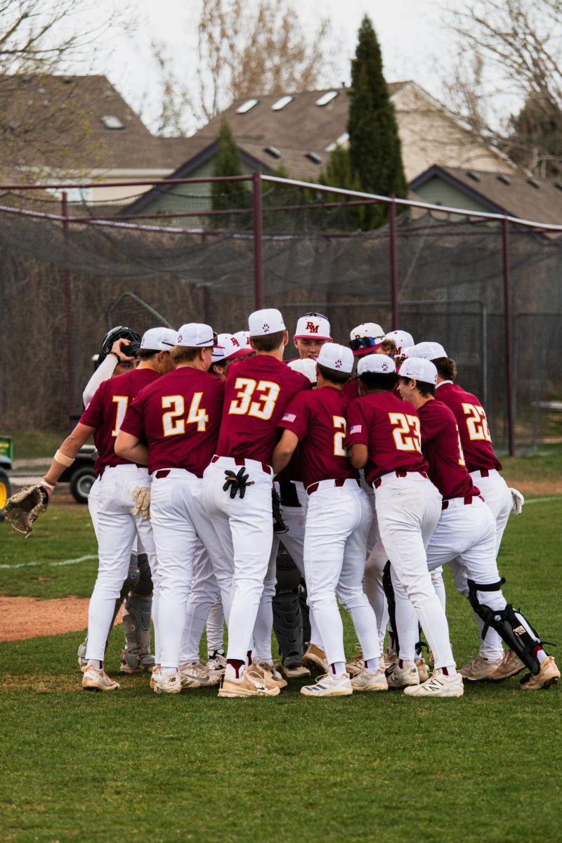 The Varsity team huddles up before playing Greeley West on March 26. 